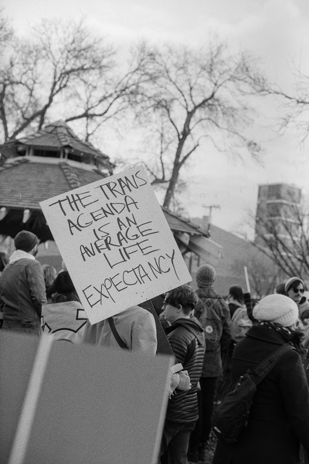 Trans rights rally with sign saying: The Trans Agenda is an Average Life Expectancy.